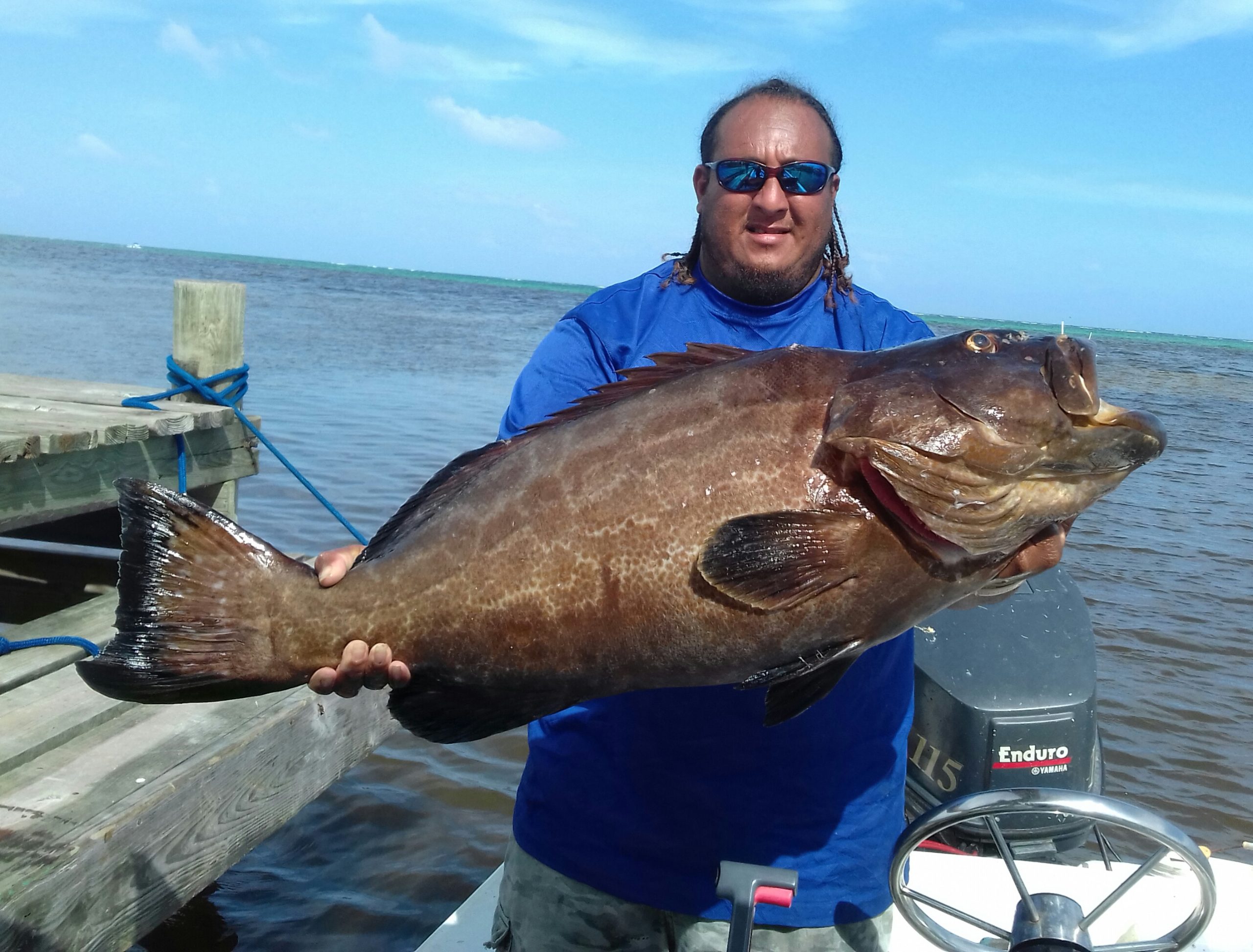 Gonzalo with a Grouper BelizeUniqueSeaAdventures Tour Guide